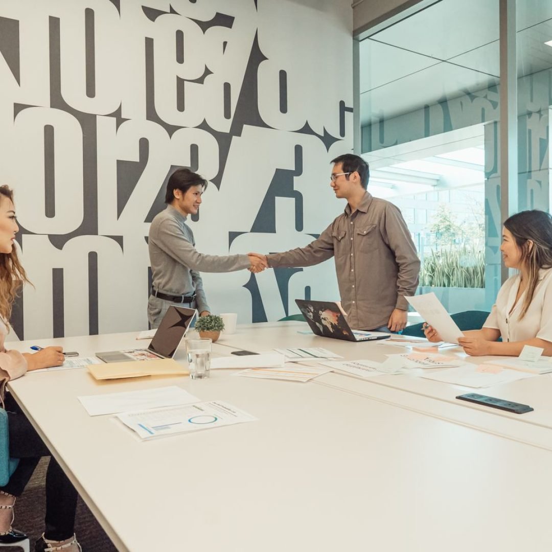 A diverse team of professionals discussing and collaborating in a modern office setting.